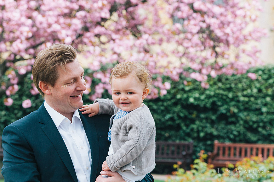 Father and son portrait with tree blossom outside St. Luke's church