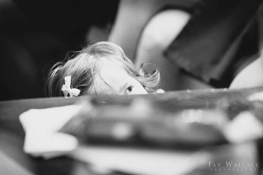 A child peaking over the top of a table