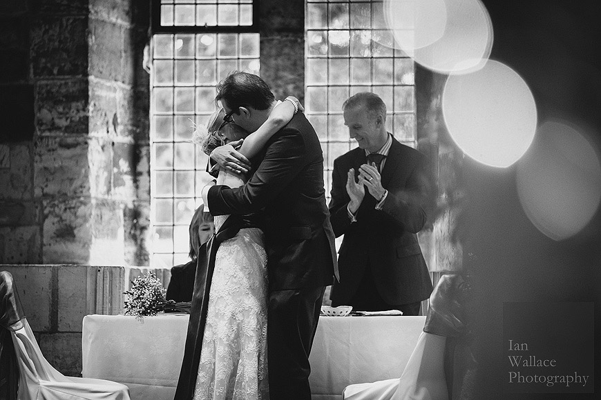 Kissing embrace - the bride and groom celebrate as they are married