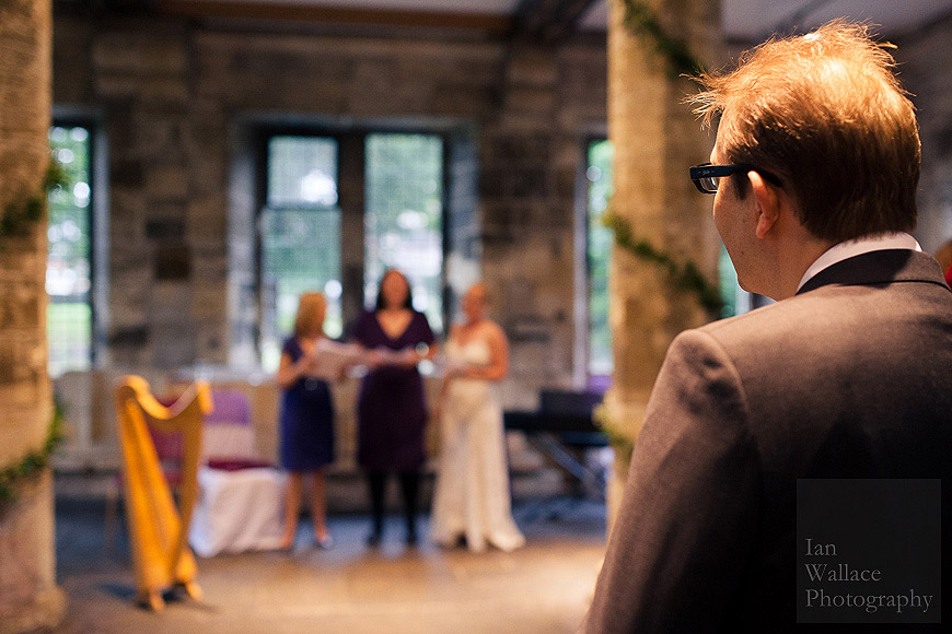 Proud husband watching bride sing with choir