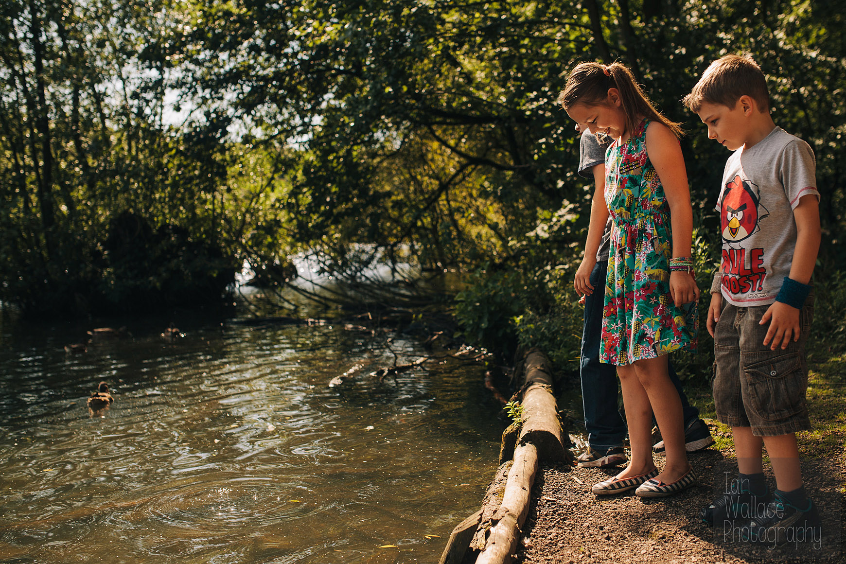 Children looking into a lake at Newmiller Dam, Wakefield