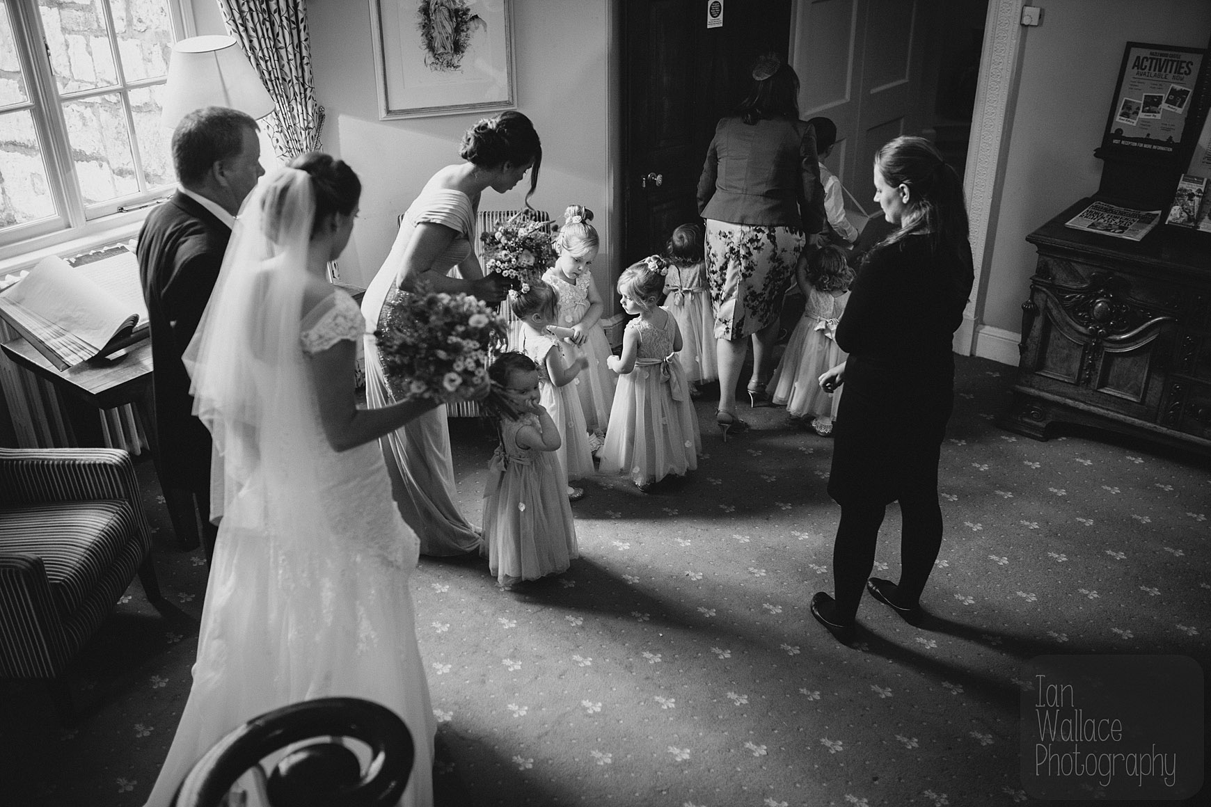 Moments before the ceremony. Bride and flower-girls gather and get organised.