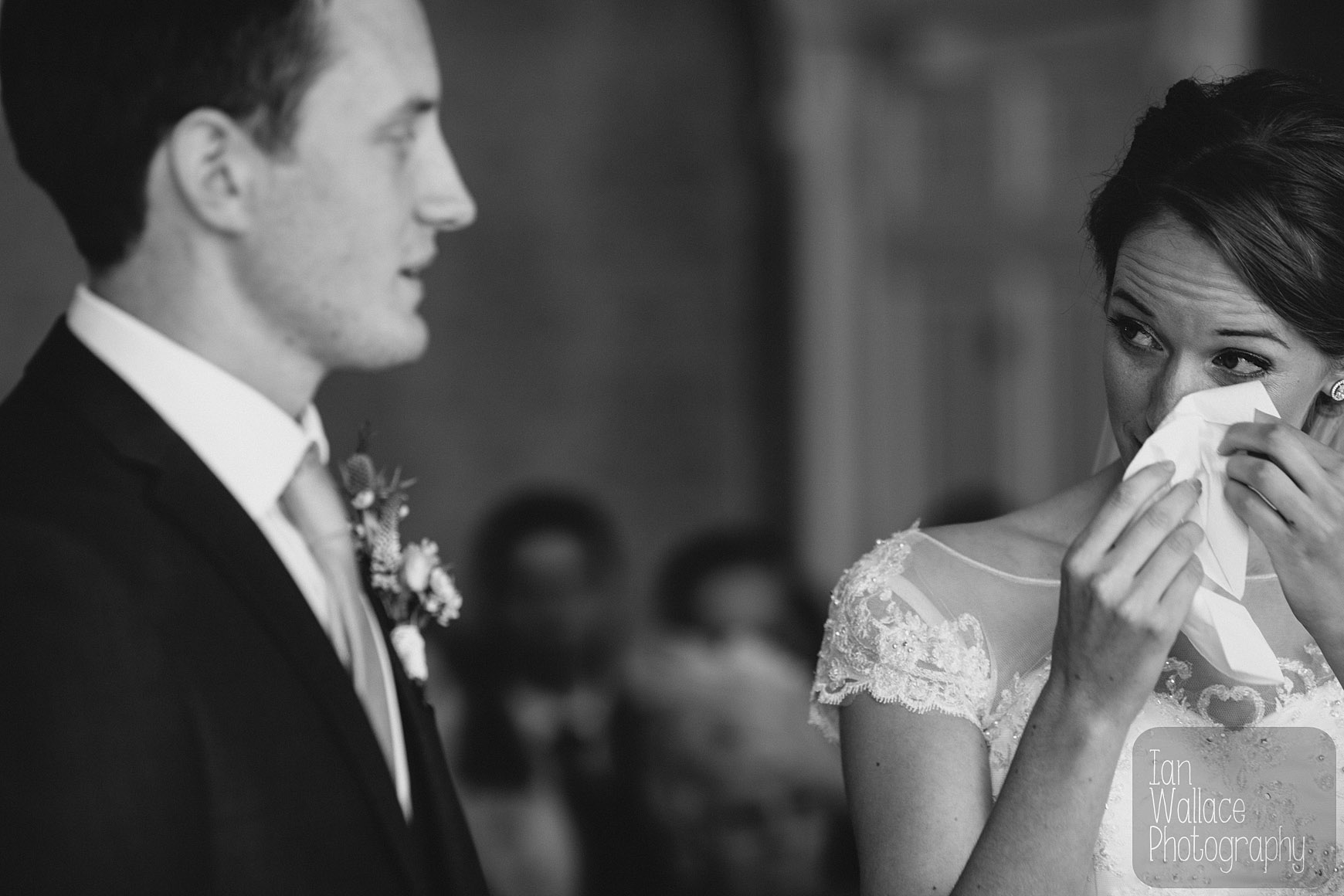 Bride drying her eyes during the ceremony.