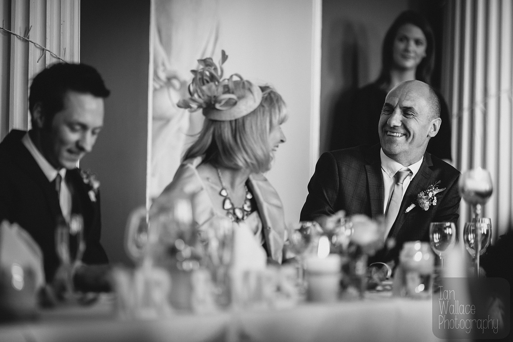 Groom's parents laughing between themselves during speeches