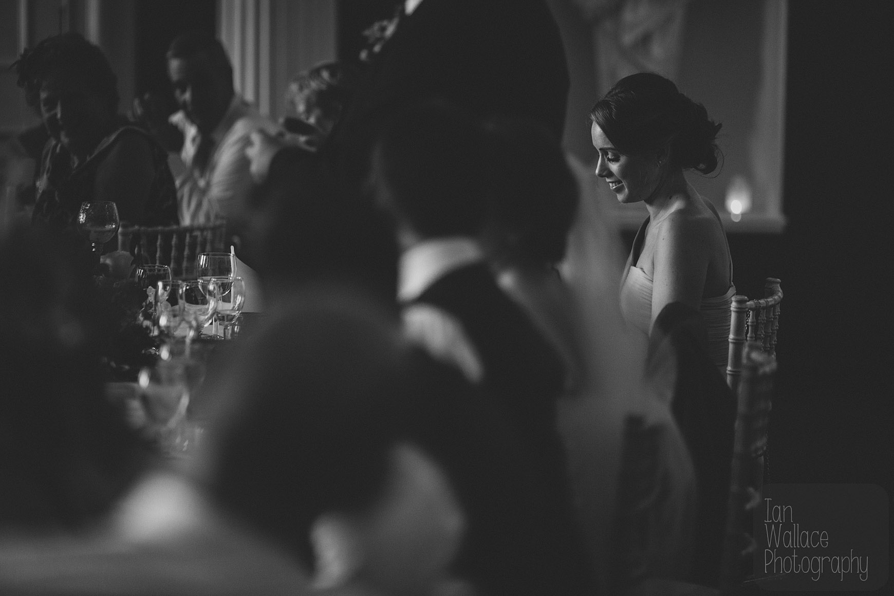 Beautiful light in a moody shot of the bride during speeches.