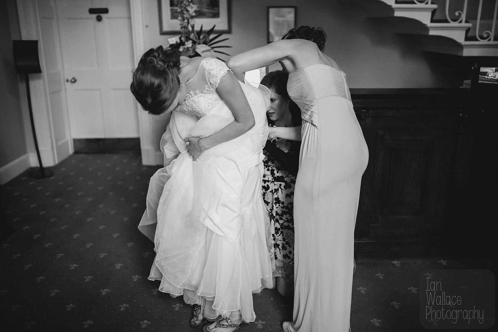The bride having her dress adjusted. Honest.