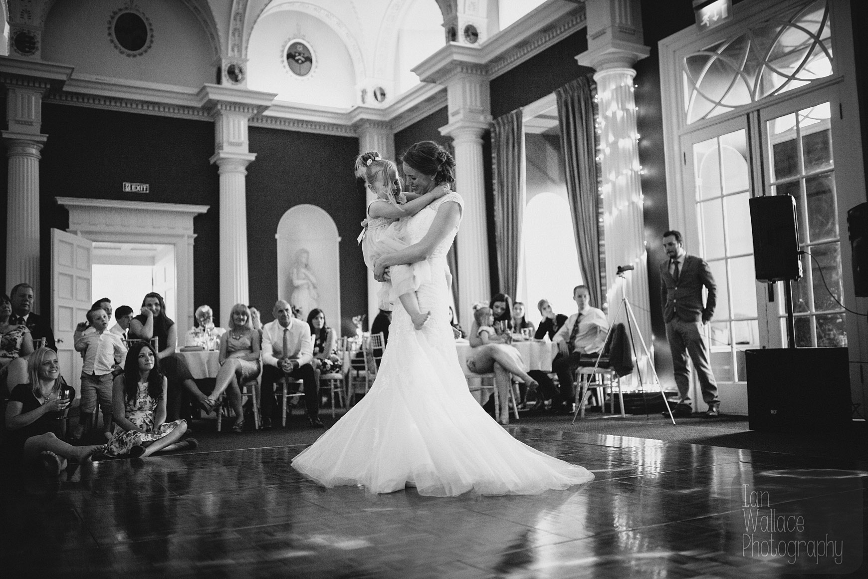 The bride spinning like a princess with a flower-girl on the dance floor