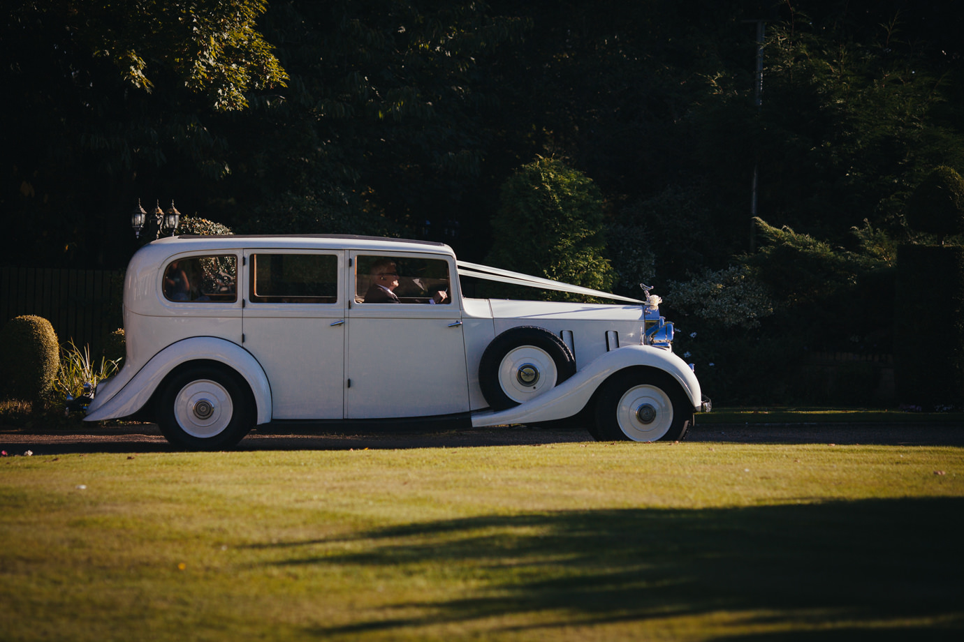 Arriving at the wedding reception venue vintage car Hemswell Court