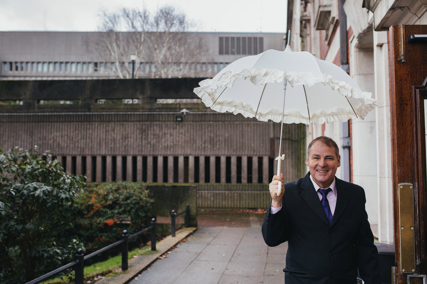 Holding the brides brolly, Manchester weather style, Stockport wedding photography